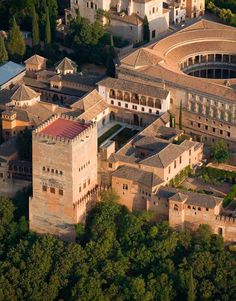 an aerial view of a large building surrounded by trees