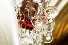 three glasses filled with liquid sitting on top of a table