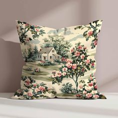 a pillow with a house and flowers on the front is sitting on a shelf next to a wall