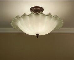 a light that is on the ceiling in a room with beige walls and white trim