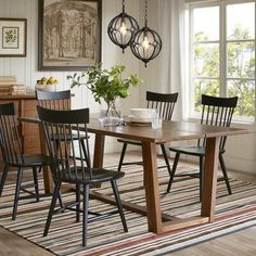 a dining room table with four chairs around it