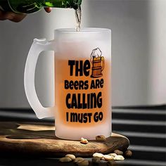 a beer being poured into a mug that says the beers are calling i must go