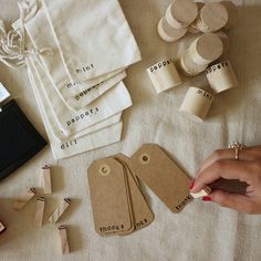 a person is making wooden tags with clothes pins and other items on a table top