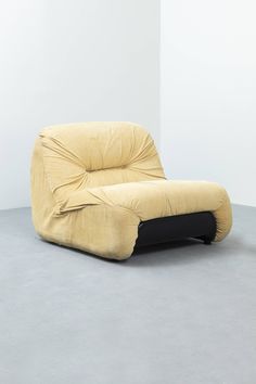 a yellow chair sitting on top of a gray floor