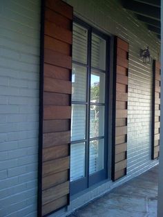 the side of a building with windows and shutters