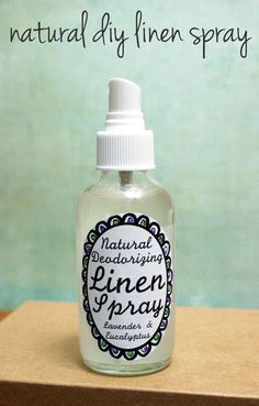 a bottle of pine spray sitting on top of a wooden table next to a green wall