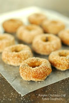 several sugared donuts sitting on top of a metal tray