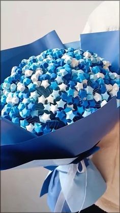 a bouquet of blue and white flowers in paper