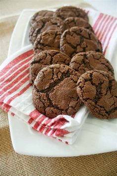 chocolate cookies on a plate with a red and white towel