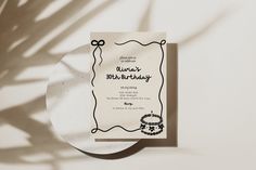 a white plate with a black ribbon around it and a birthday card on the front