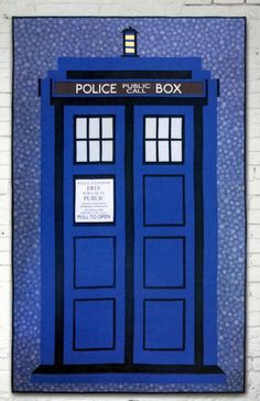 a blue tardish with the words police box on it's front and side