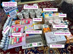 a table topped with lots of different items on top of a red carpeted floor