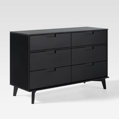 a black dresser with six drawers on it