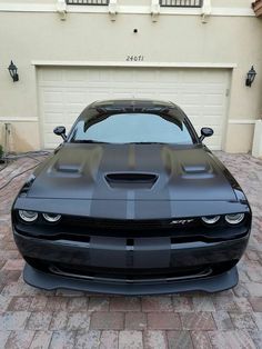 a black car parked in front of a garage