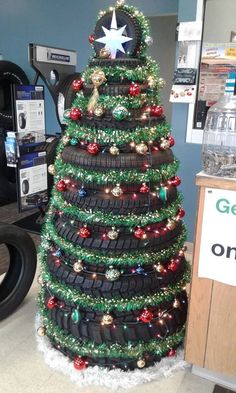 a christmas tree made out of tires is on display in a store's office