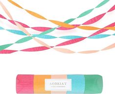 a tube of colored toothpaste on top of a white background with colorful streamers