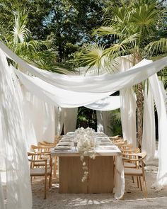 a long table with white draping over it