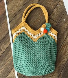 a crocheted bag sitting on top of a wooden floor