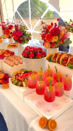 a table topped with lots of different types of food and drinks next to each other