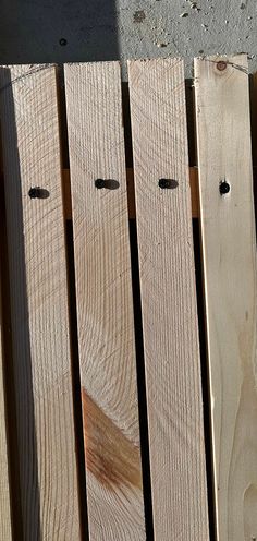 several pieces of wood sitting next to each other on a wooden pallet with holes in them