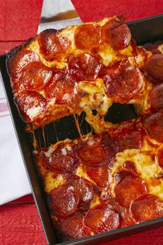 two slices of pepperoni pizza in a pan