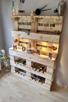 a wooden pallet filled with lots of bottles and wine glasses on top of it