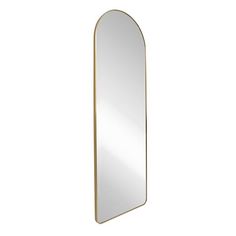 a mirror that is standing up against a white wall and has a gold frame around it