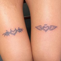 two small tattoos on both legs with hearts and wings in the shape of a heart