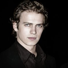 a young man with curly hair and blue eyes