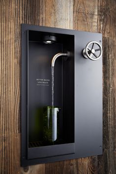 a water faucet is attached to the side of a wall mounted bottle opener