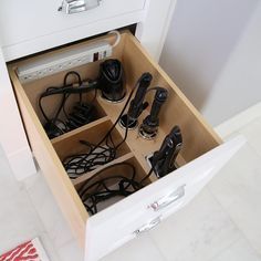 an open drawer with several pairs of shoes in it