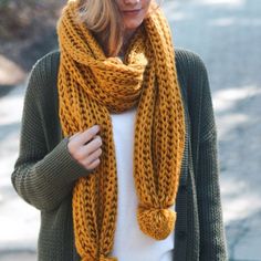 a woman wearing a yellow knitted scarf