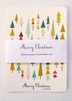 a merry christmas card with colorful trees on the front and white envelope, which reads merry christmas