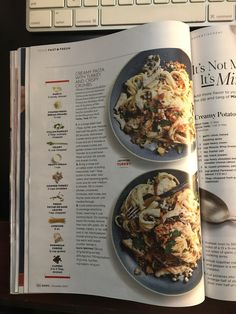 an open magazine with two plates of food in front of a computer keyboard and mouse