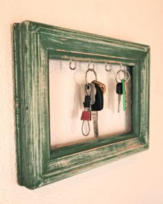 a green frame with keys hanging on it