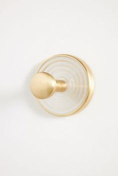 a gold door handle on a white wall