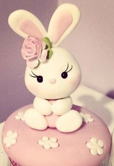 a cupcake decorated with an adorable bunny sitting on top of it