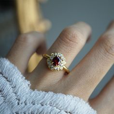 Indulge in timeless romance with the Rosaire spinel ring. Featuring a vibrant spinel center stone in a French-inspired setting, this ring captures and reflects light beautifully, reminiscent of Parisian nights. Crafted with delicate filigree, the Rosaire exudes elegance and vintage charm, making it the perfect symbol of eternal love. Ideal as a gift or a cherished addition to your collection, this stunning ring is a true treasure. All orders come in our Tippy Taste ring box. This ring is handmad Rings With Red Stones, Gem Rings, Red Stone Ring, Red Spinel, Diy Jewelry Unique, Spinel Ring, Gem Ring, Charm Making, Wedding Goals