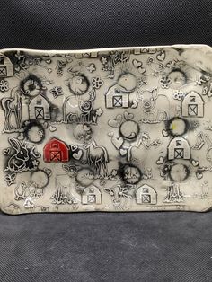 a ceramic tray with farm animals on it