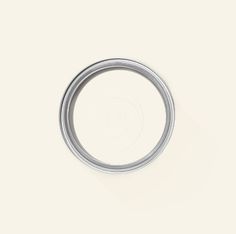 an empty silver ring on a white surface