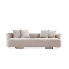 a white couch with four pillows on it