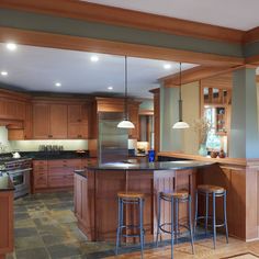 a large kitchen with wooden cabinets and an island