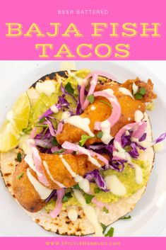 a white plate topped with fish tacos covered in sauce