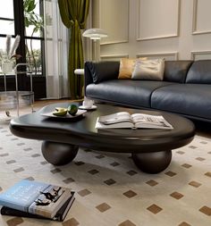 a living room filled with furniture and a book on top of a wooden coffee table