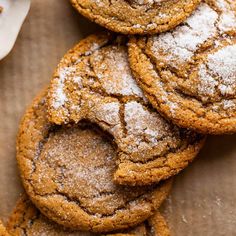 a pile of cookies with powdered sugar on top