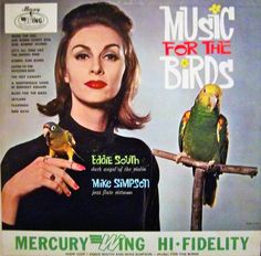 a magazine cover with a woman holding two birds on her arm and one bird perched on the branch