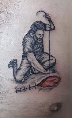 a man with a tattoo on his stomach holding a golf club and sitting on the ground