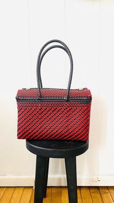 "Each bag begins in the small villages of Oaxaca, Mexico, handcrafted by creative and powerful artisans. Each bag is truly one of a kind piece. Featured in this listing is a black and red  tote.  *Handwoven *One thick handle on each side of the bag for extra security  *Easy maintenance  *Eco-friendly *Reusable *Fashionable *Lightweight  *Waterproof *Durable Please feel free to email me if you have any questions. Thank you! Bag measurements: 12\" W x 7.3\" H x 5.5\" D with a strap drop of 10\"." Mexican Bag, Thank You Bags, Plastic Basket, Plastic Baskets, Bag Lunch, Box Lunch, Insulated Bags, Red Tote, Bag Measurements