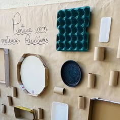 there are many pieces of paper and other things on the wall that is made out of cardboard