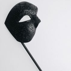 This masquerade mask on a handheld stick is perfect for those who love the mystique of masked characters. The intricate hand painted black shimmer filigree adds sophistication. Channel your inner Phantom and captivate others at masquerade parties, balls, weddings, and more!
This mask is available in different colors for the mask as well as different colors for the filigree design, along with the option for satin ribbons or a handheld stick.


Age Group/Gender - Adult/Men

Size/Type - One size fi Medieval Black Masquerade Mask, Luxury Black Halloween Masquerade Mask, Luxury Black Elegant Masks, Adjustable Black Fantasy Masquerade Mask, Elegant Black Theater Mask, Phantom Mask, Black Masquerade Mask, Mask Guy, Mask Style